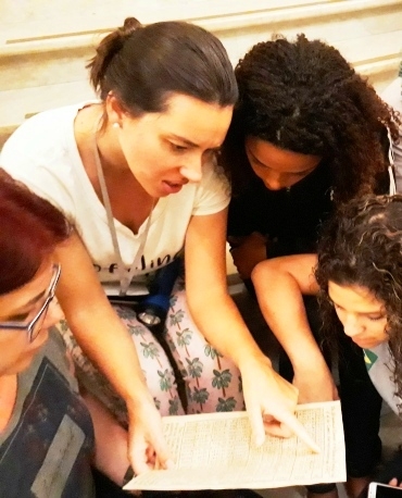 A museóloga Patricia Matos avaliando os dados da pista achada pelas meninas